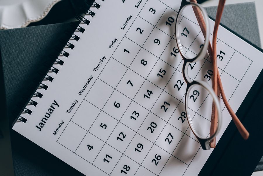 Appointment calendar with glasses and a pencil